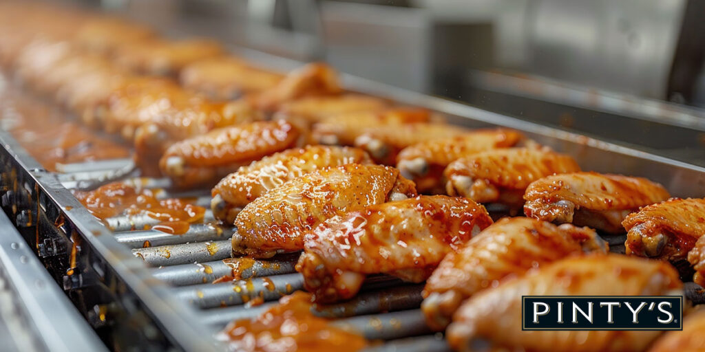 Chicken wings on a processing line
