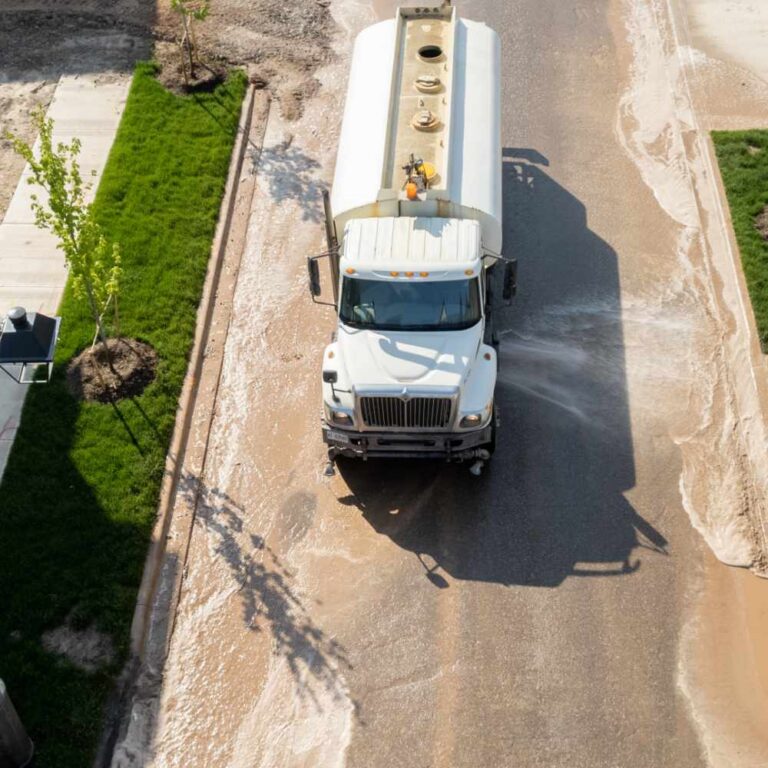 Commercial Road Washing and Road Flushing Truck on the road doing an assessment of a property.