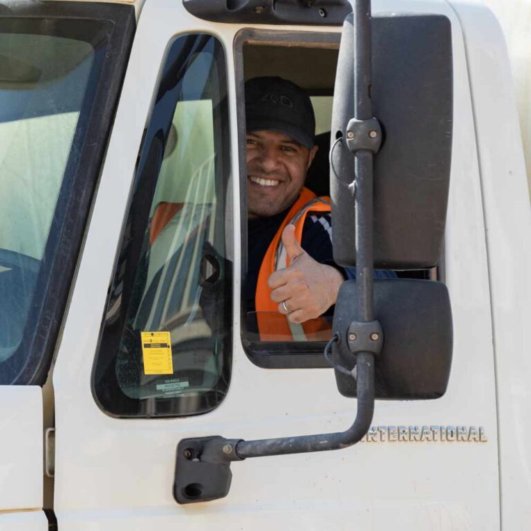 Commercial Road Washing and Road Flushing Employee sticking a thumbs-up to show that the job was done properly.
