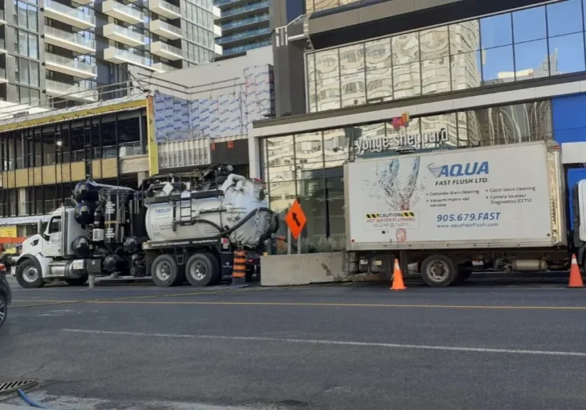 Commercial-highpressure-flushing-and-vacuuming-at-Young-Sheppard-Centre-downtown-TO-1920w Aqua Flush high-pressure flushing truck on a job site.